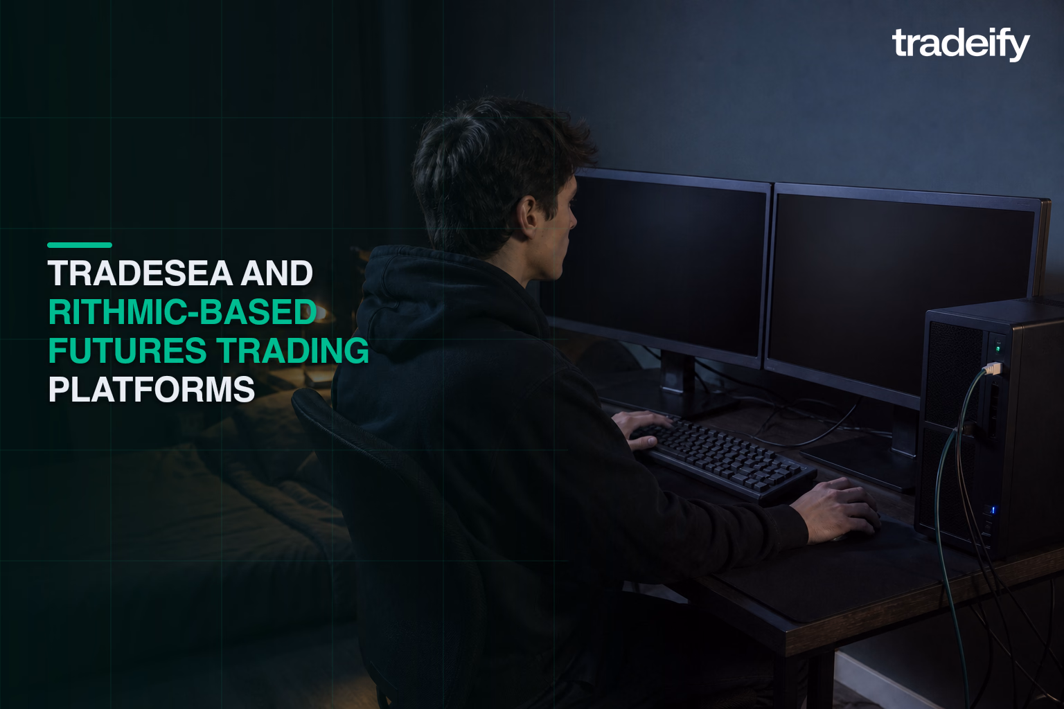 Young trader at a wired dual-monitor desktop setup for low-latency futures execution