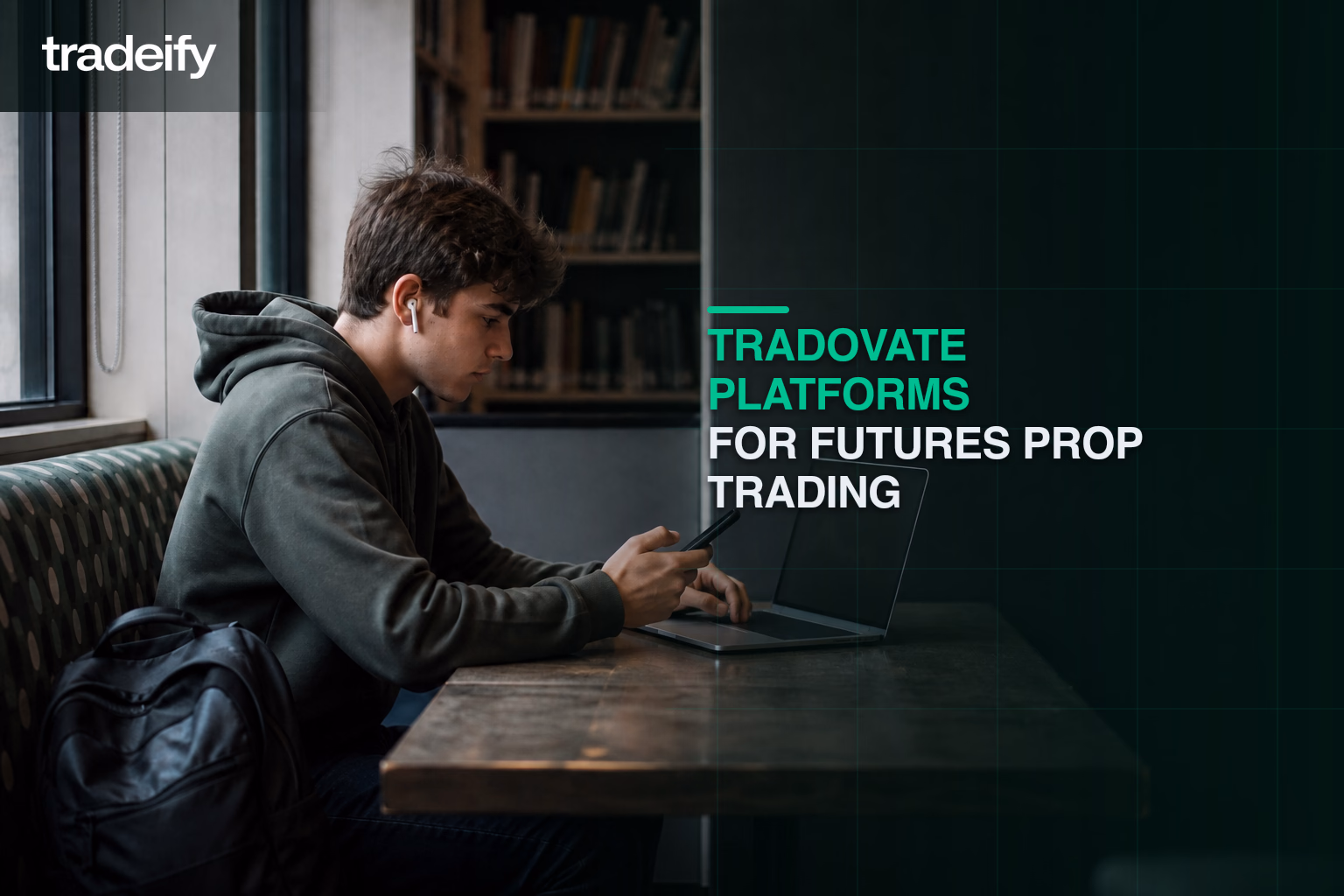 Young trader using a blank browser laptop and phone in a campus library booth