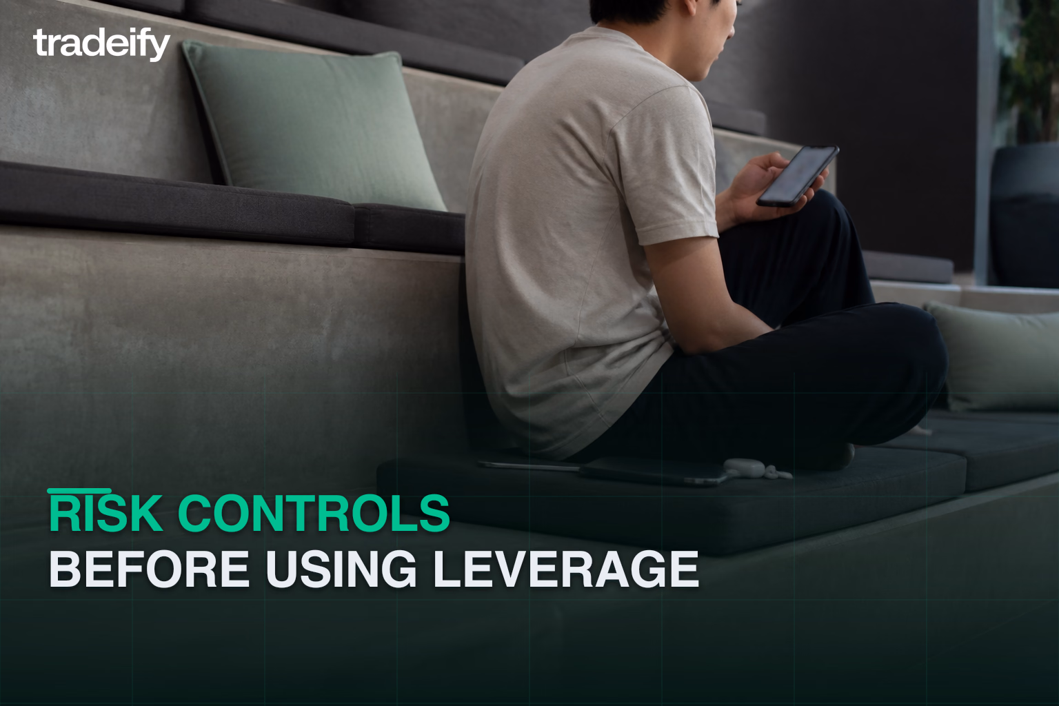 Young futures trader reviewing position risk on a phone before changing leveraged contract size