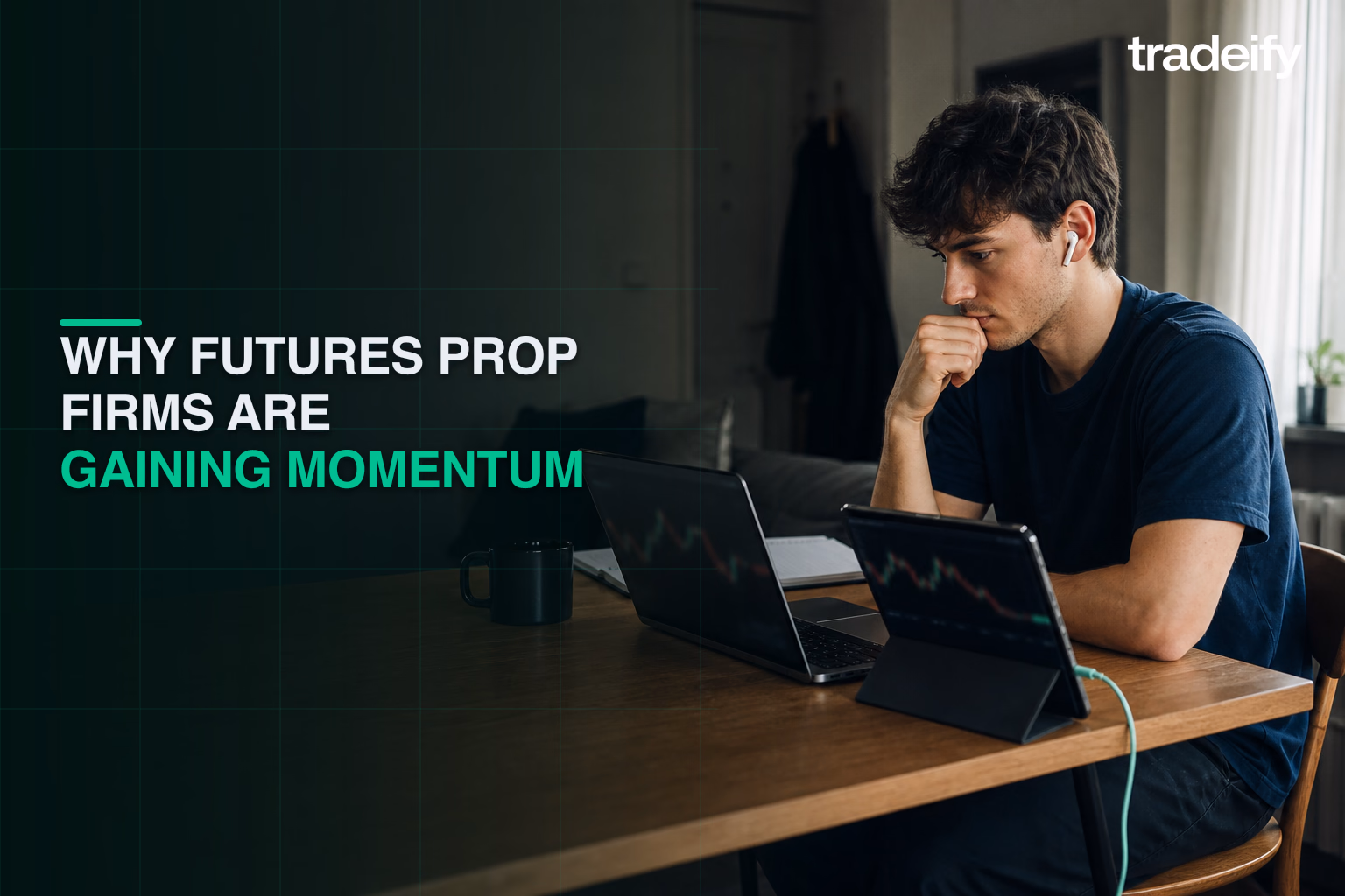 Young futures trader learning from softly defocused chart shapes on a laptop at a compact dining table
