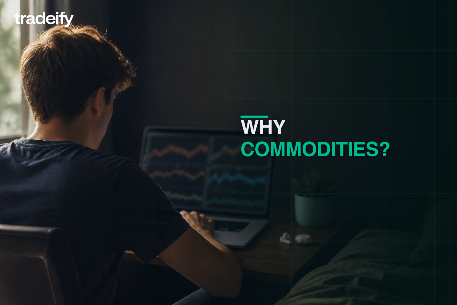 Young trader studying several softly defocused commodity-market charts from a small bedroom workstation