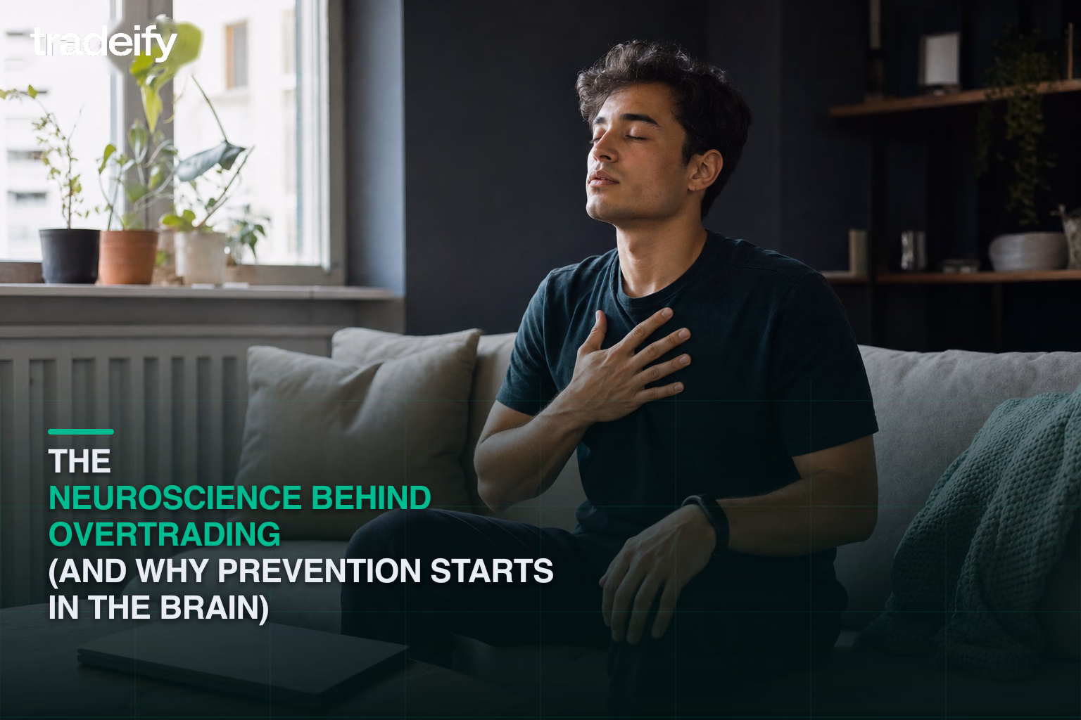 Young trader using a quiet breathing reset beside a closed laptop after a stressful session