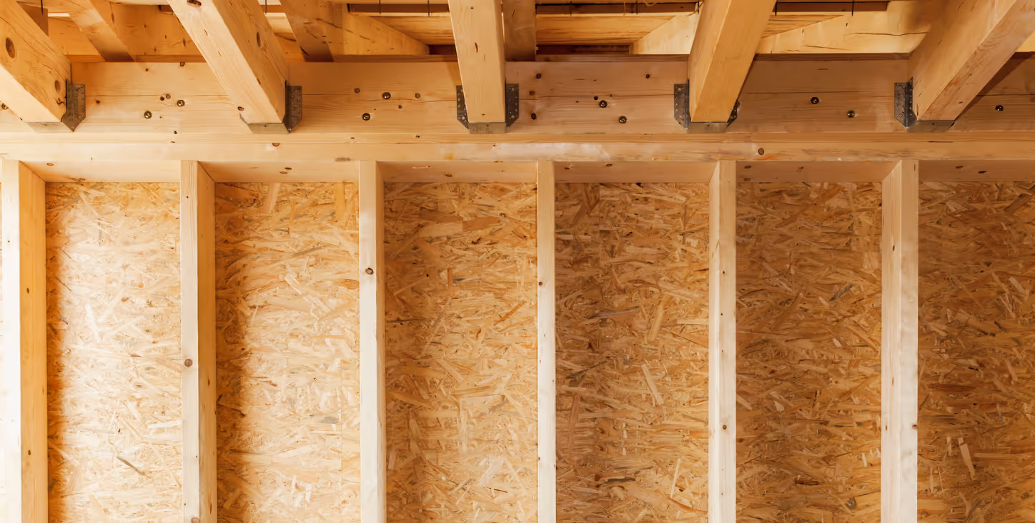 Holzständerwerk für eine Trockenbauwand im Rohbau – vertikale und horizontale Träger in einem Neubauprojekt.