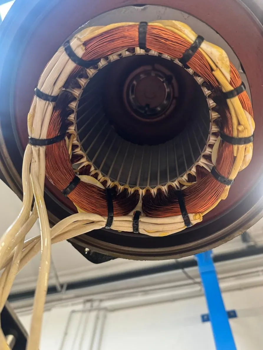 Close-up of a red fire sprinkler head covered in dark dust and corrosion.