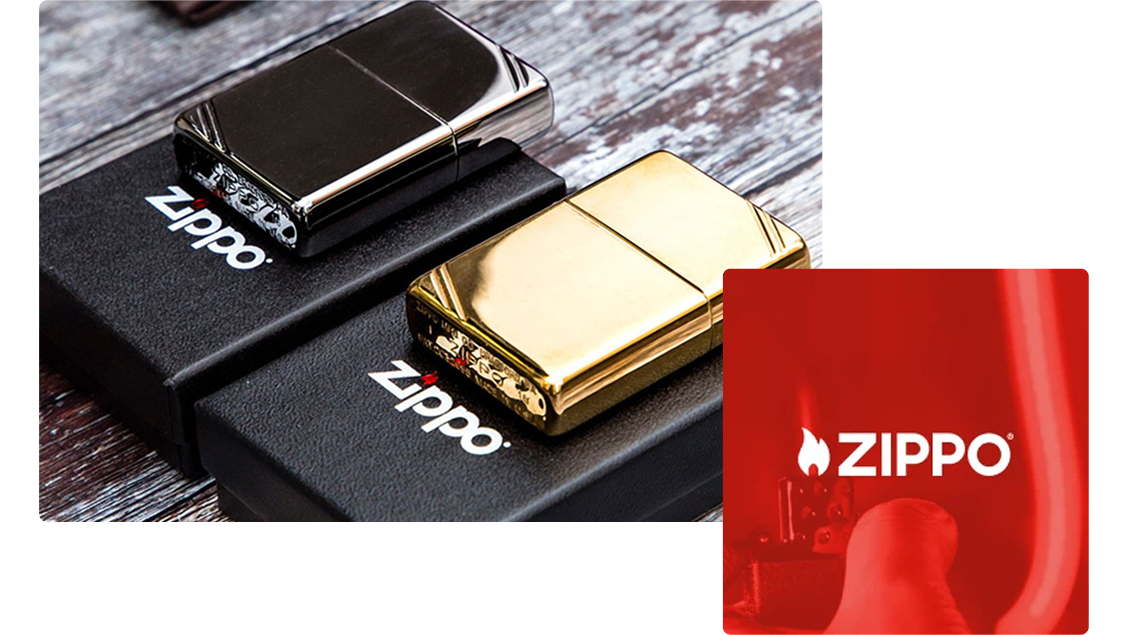 Two metallic Zippo lighters, one silver and one gold, placed on black Zippo-branded boxes on a wooden surface.