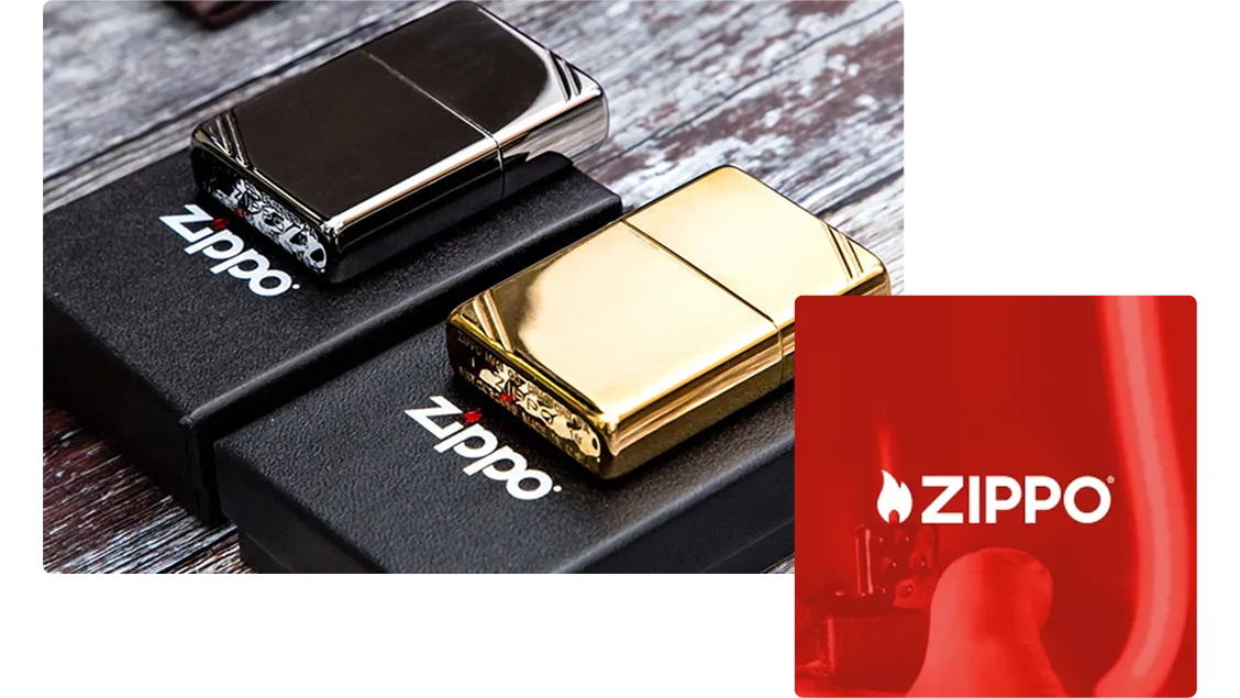 Two metallic Zippo lighters, one silver and one gold, placed on black Zippo-branded boxes on a wooden surface.
