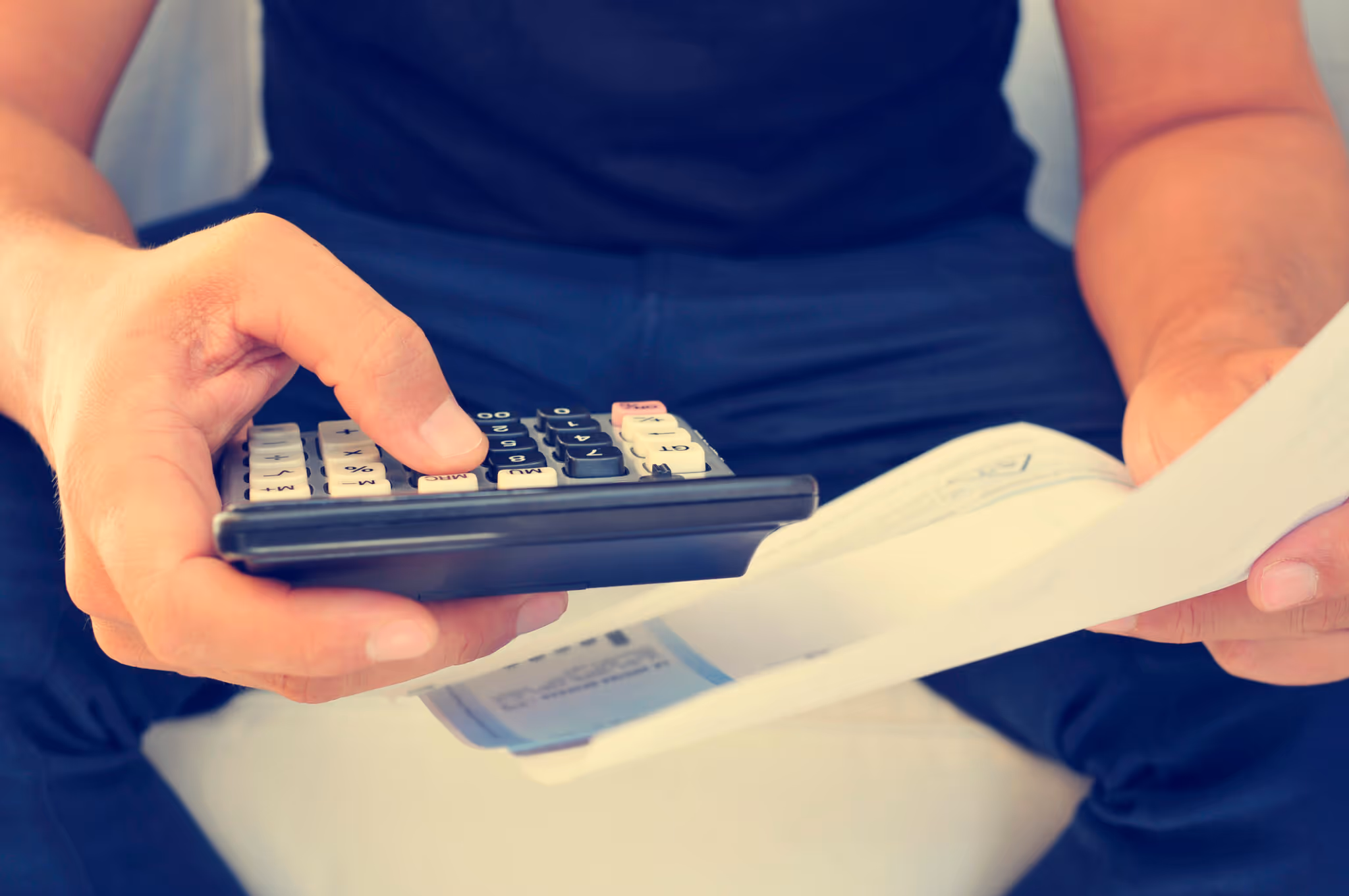 young man checking a bill, a budget or a payroll, filtered
