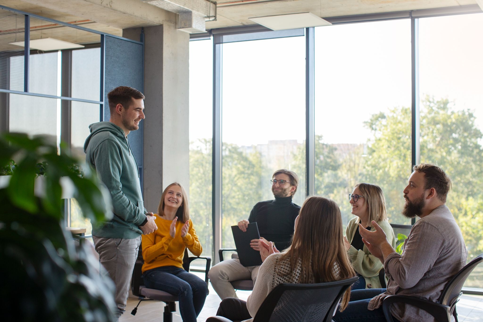 Group therapy session with individuals sharing support and participating in recovery-focused counseling in a treatment setting