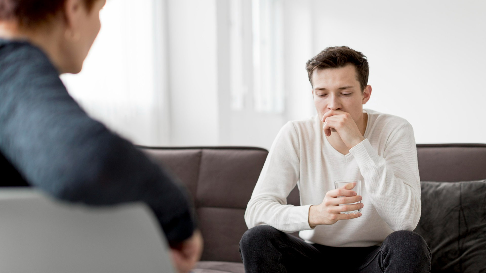 Person in an outpatient therapy session sitting with a counselor while reflecting on recovery, representing individualized addiction treatment, emotional support, and relapse prevention.