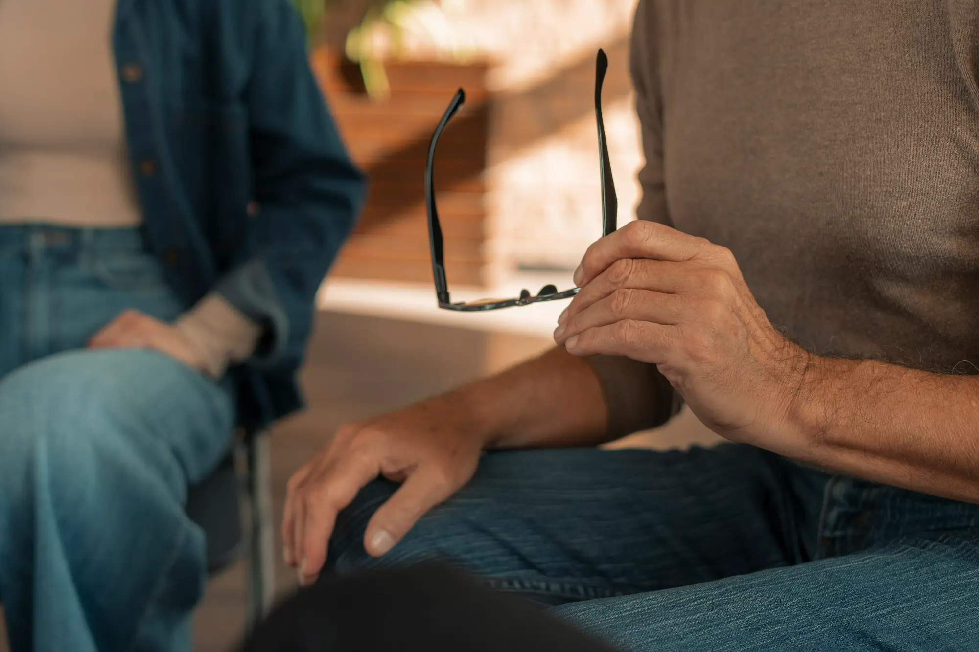 Two adults discussing addiction treatment and recovery options during a counseling session