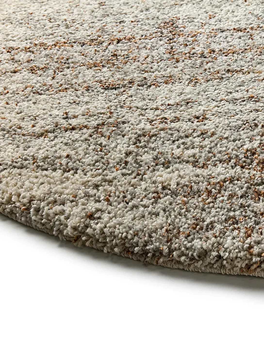 Close-up of a curved carpet with a textured surface featuring a mix of light gray and brown fibers.