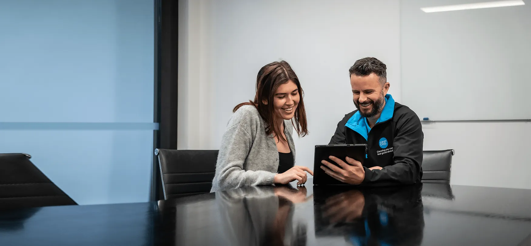 clean corp staff looking at a tablet
