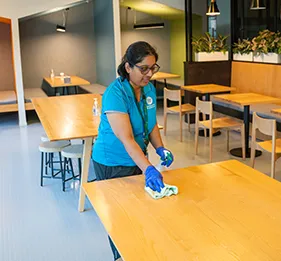 clean corp staff cleaning table