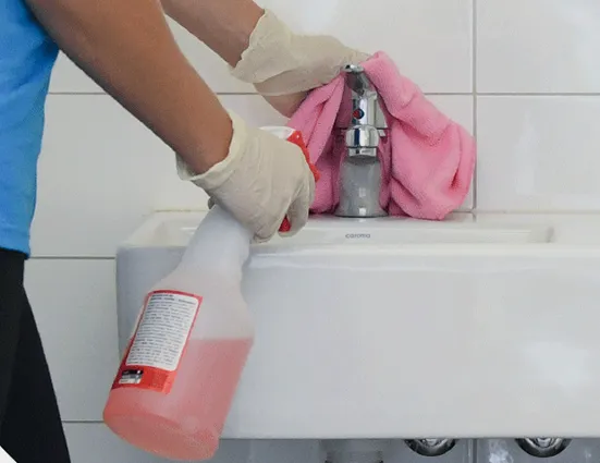 clean corp staff cleaning bathroom