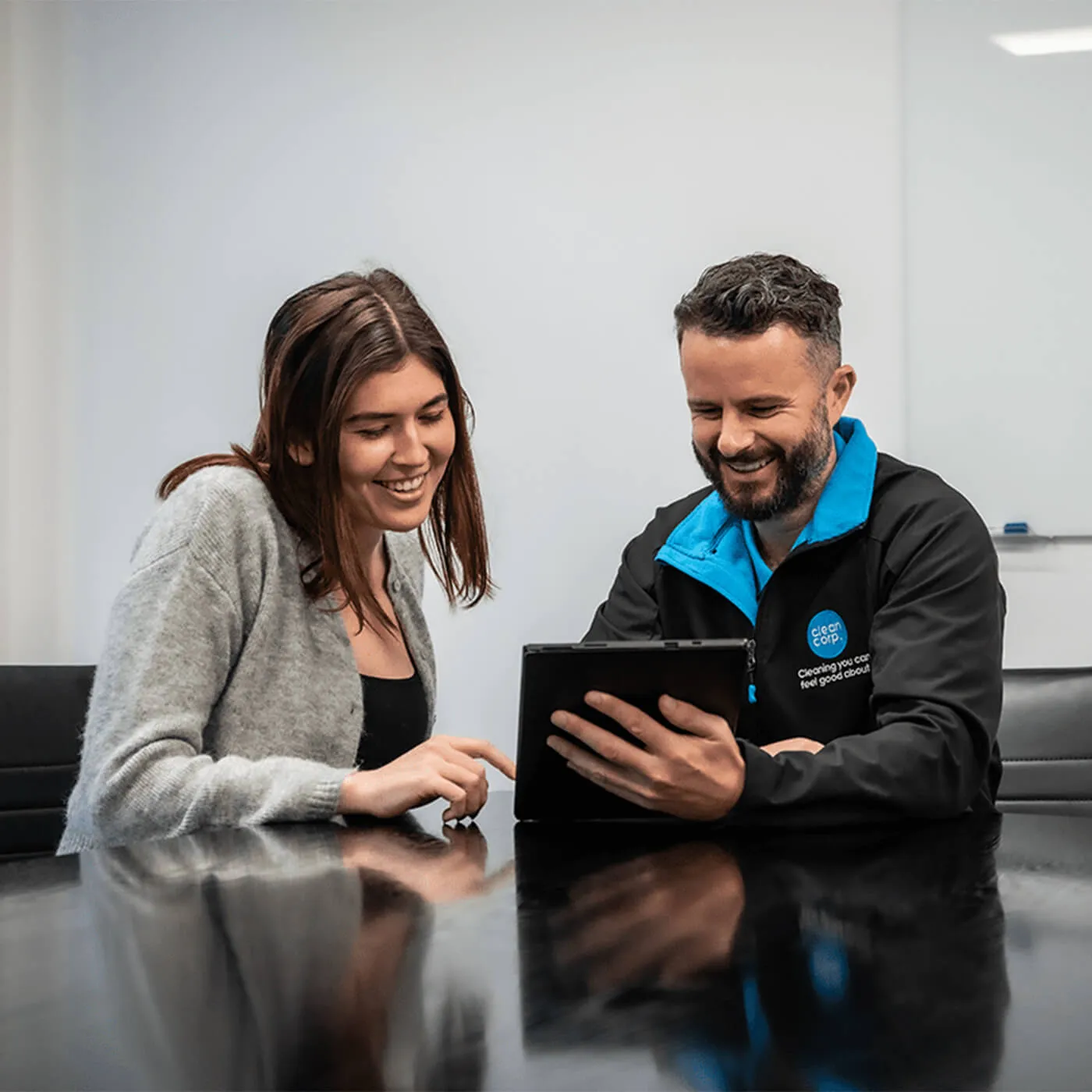 clean corp staff looking at a tablet