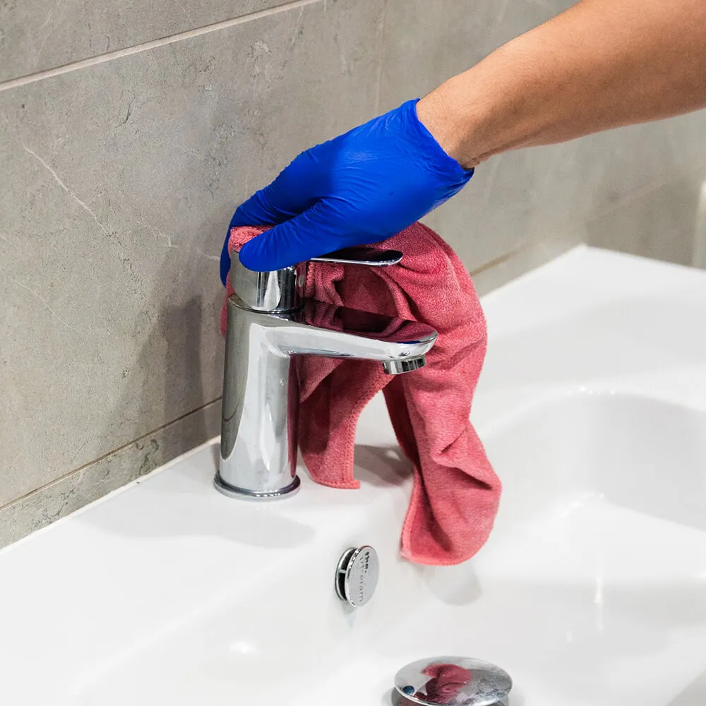 clean corp staff cleaning bathroom