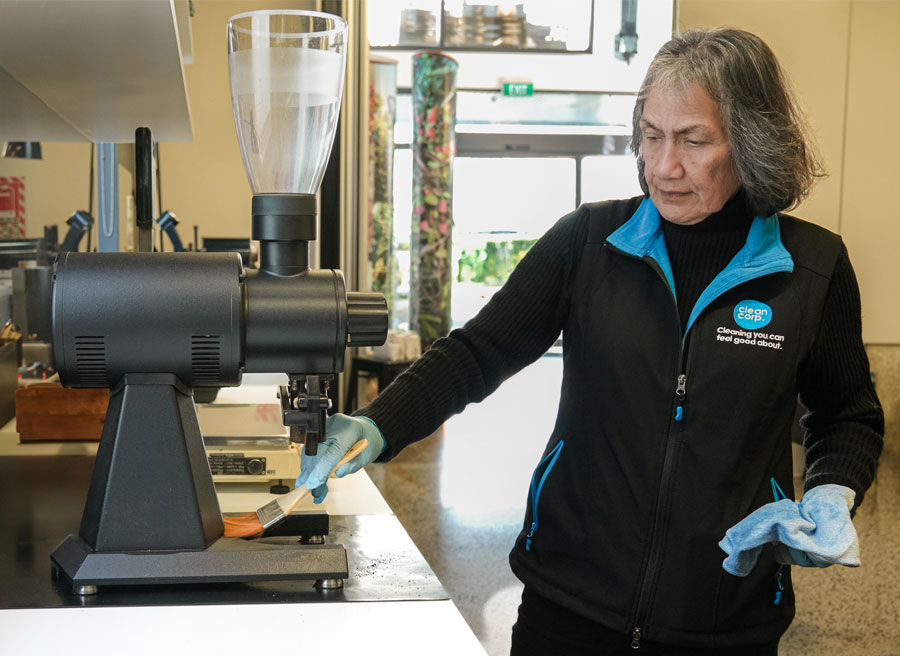 clean corp staff cleaning coffee machine