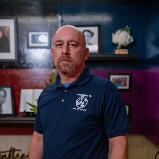 Staff member from Middle School 180 Colvin House in navy polo