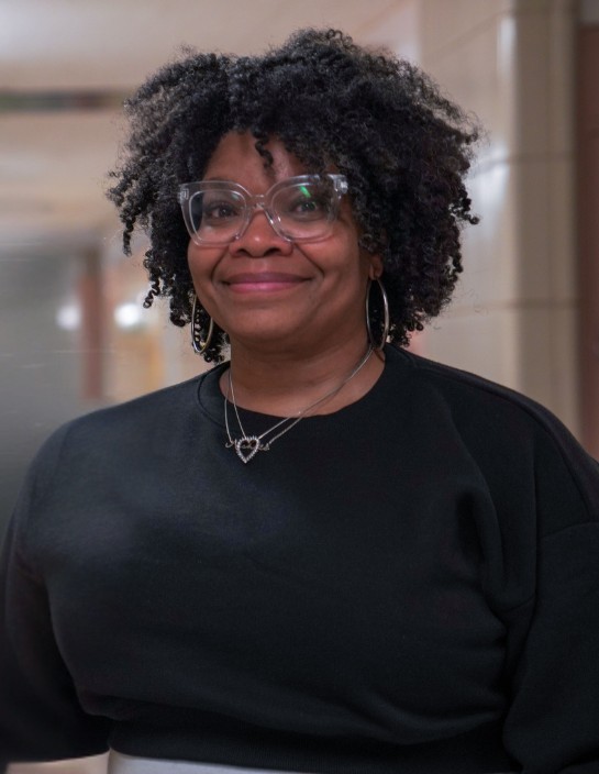Staff member Ms. Mills smiling in school hallway