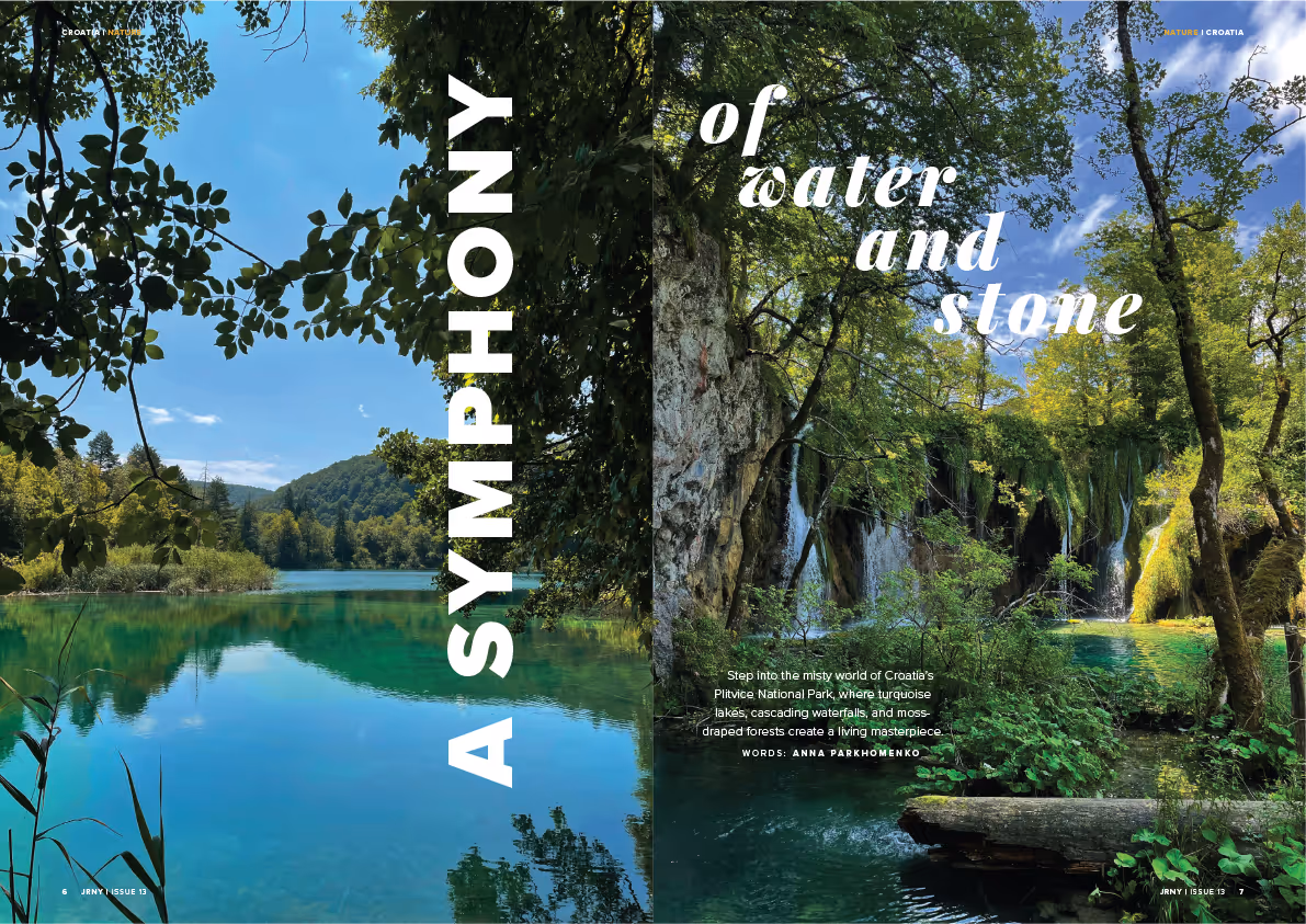 Turquoise lake and lush green forest with cascading waterfalls at Croatia’s Plitvice National Park under a blue sky.