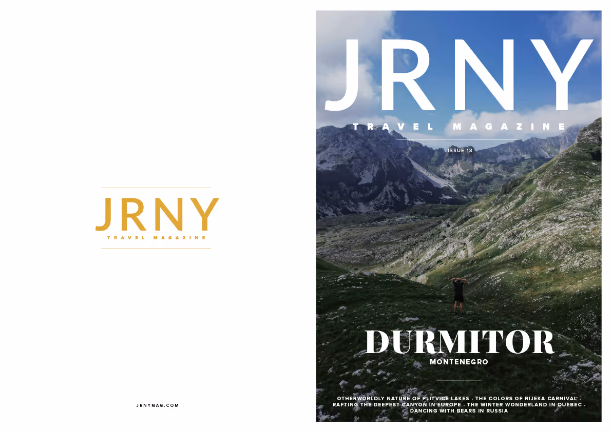 Cover of JRNY travel magazine Issue 13 featuring a person standing in a green mountainous landscape with rocky peaks under a blue sky, titled Durmitor Montenegro.