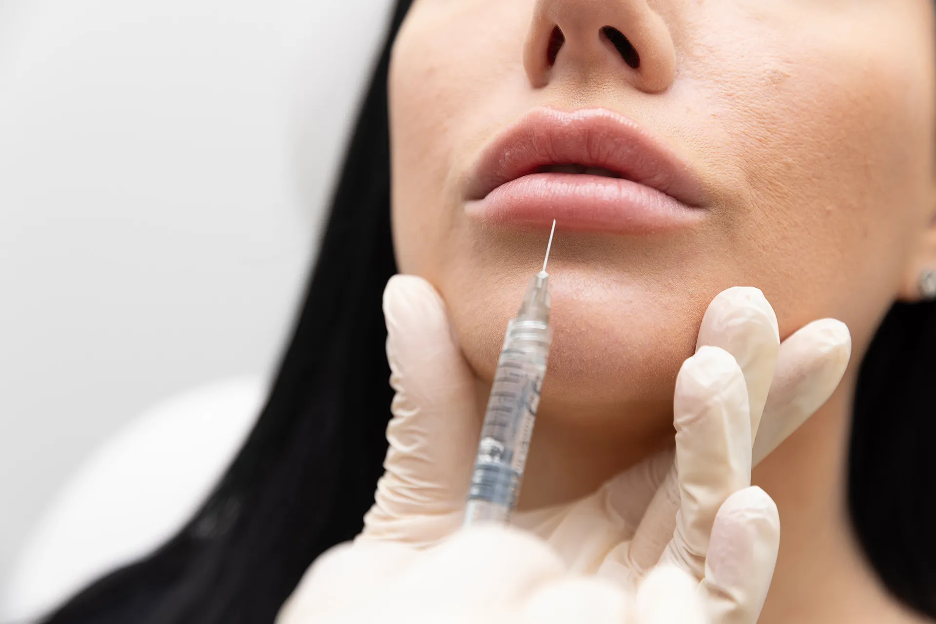 A woman receiving an injection in her lips