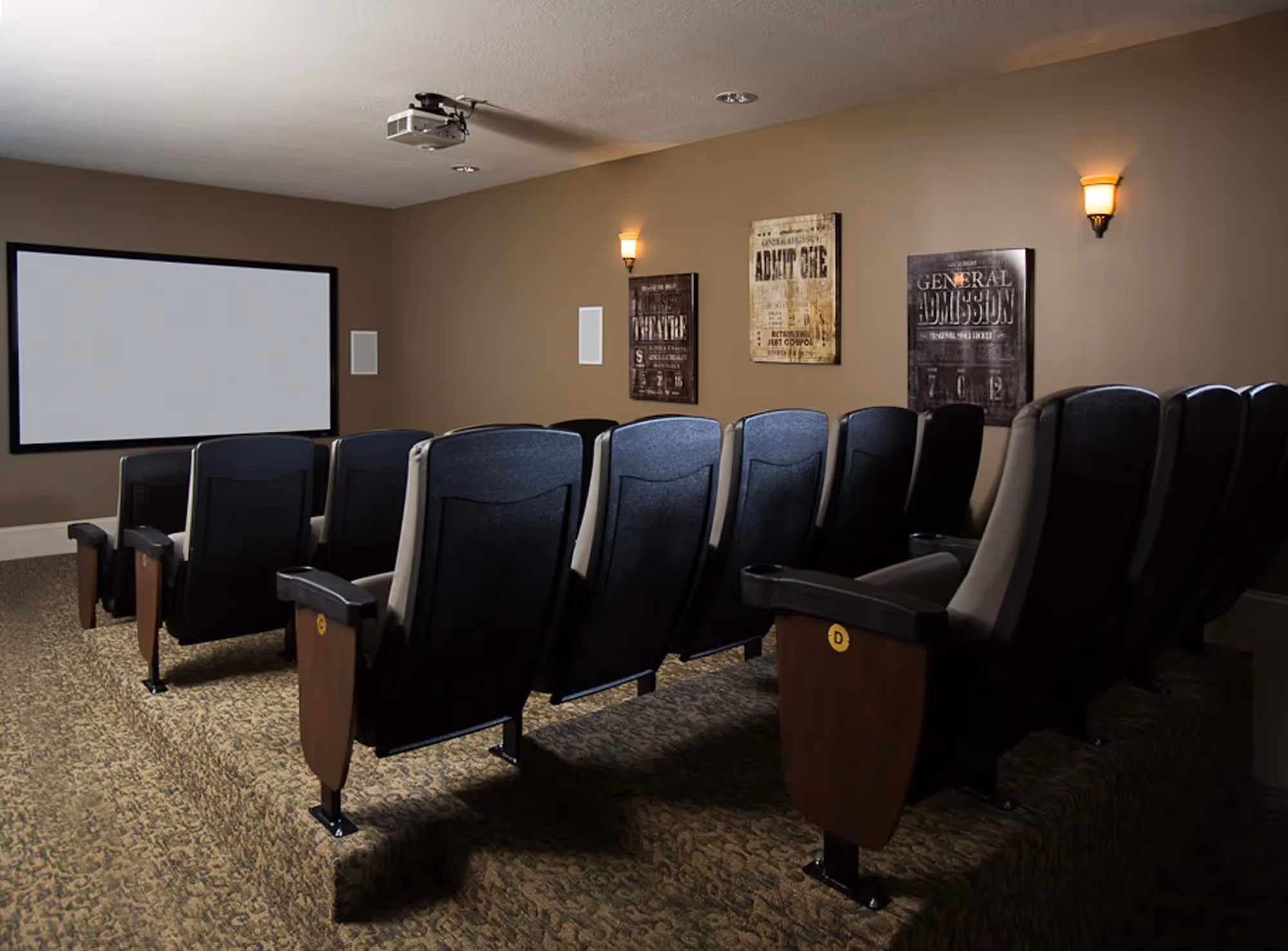 movie theatre room with chairs and screen