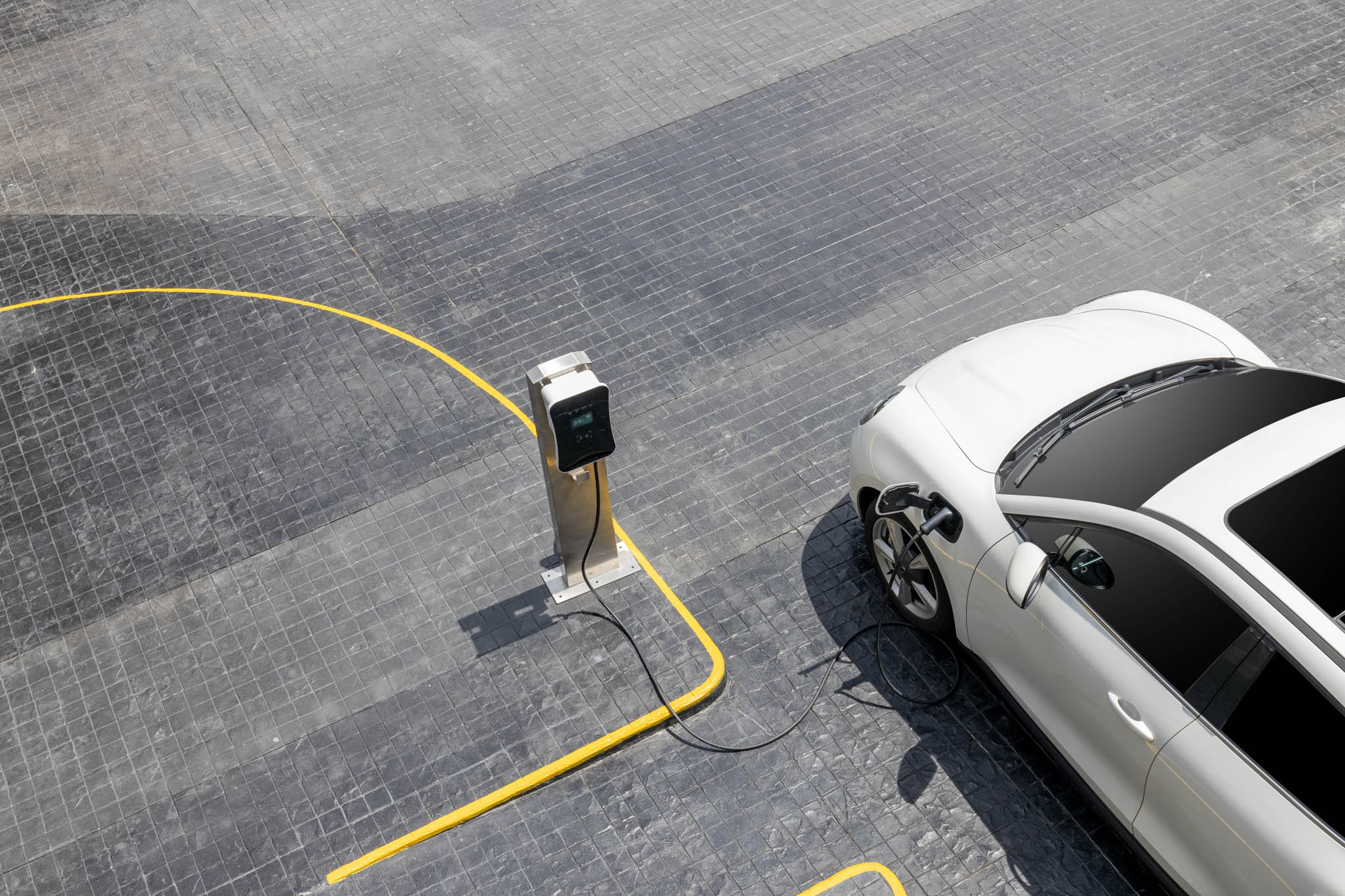 An electric car sitting next to an electric vehicle charging station.
