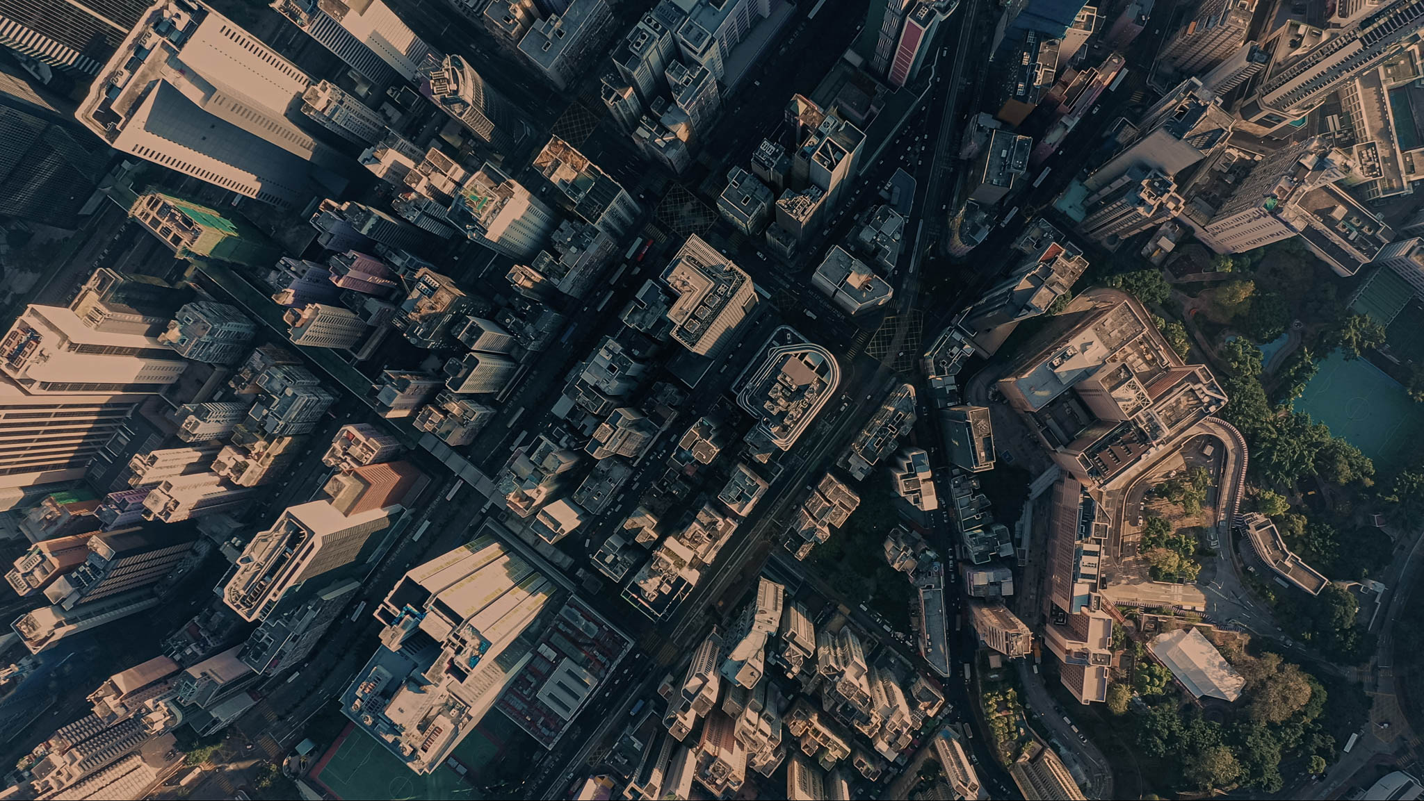 Birds eye view of a busy city seeing roads and transport.