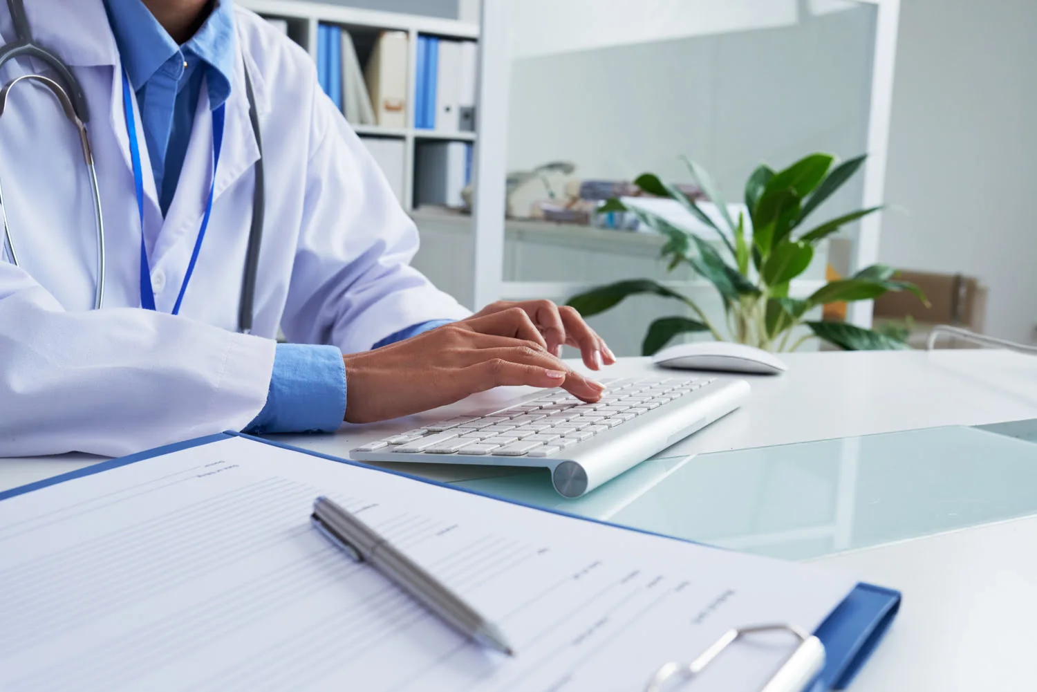 doctor typing on a keyboard