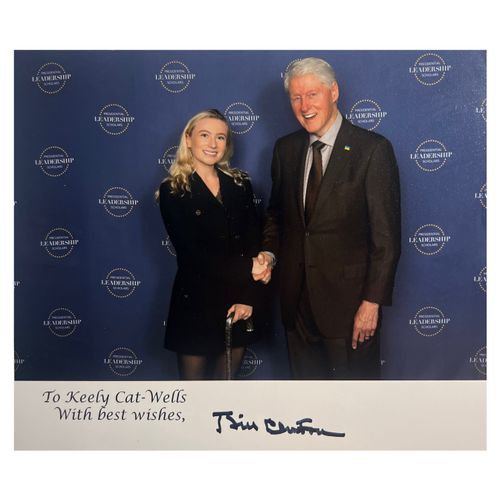 President Clinton with shakes hands with Keely in a formal photo