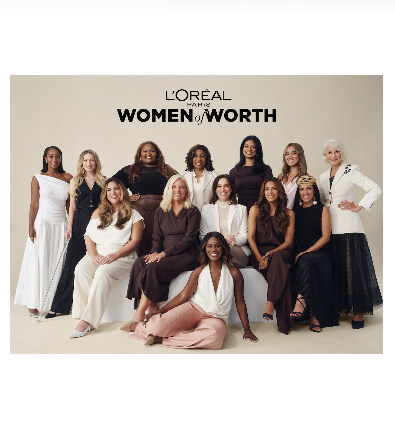  A diverse group of thirteen women (ten honorees and Helen Mirren, Eva Longoria and Aja Naomi King) are posed together against a beige background beneath the black text “L’Oréal Paris Women of Worth.” The women are smiling confidently. They are dressed in elegant neutral tones. Some are seated in the front row while others stand behind them, creating a warm, balanced composition that highlights collective strength and celebration.
