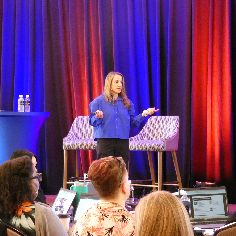 Dr. Nicole L'Etoile speaking to an audience at a conference.
