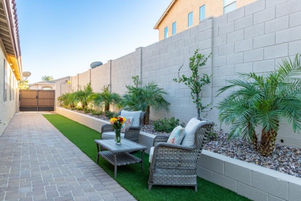 Outdoor seating beside a landscaped walkway at Ohana Straight Arrow North.