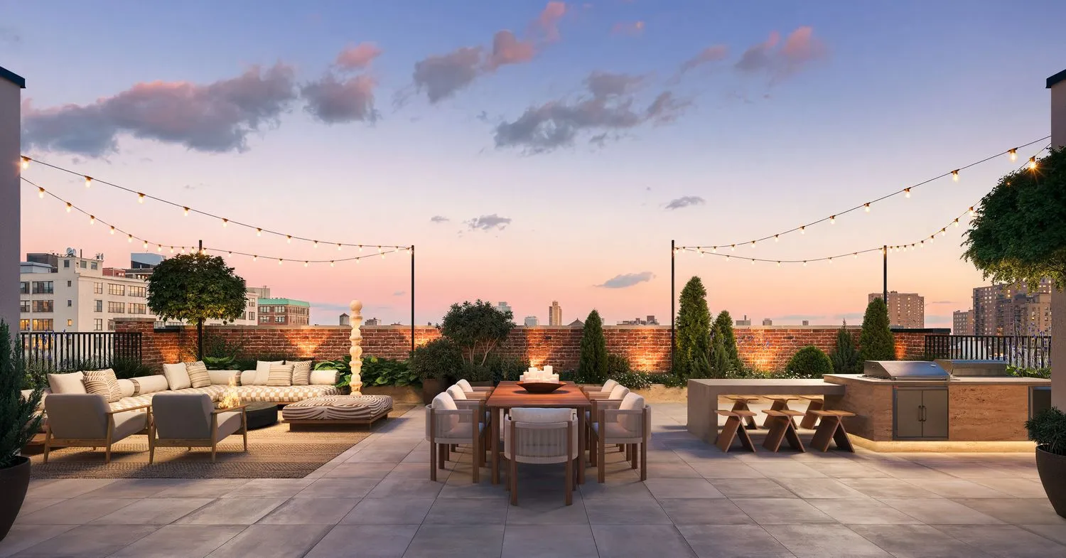 Private rooftop terrace with skyline views, lounge seating and string lights at The Candy Factory, 124 Washington Avenue, Clinton Hill, Brooklyn