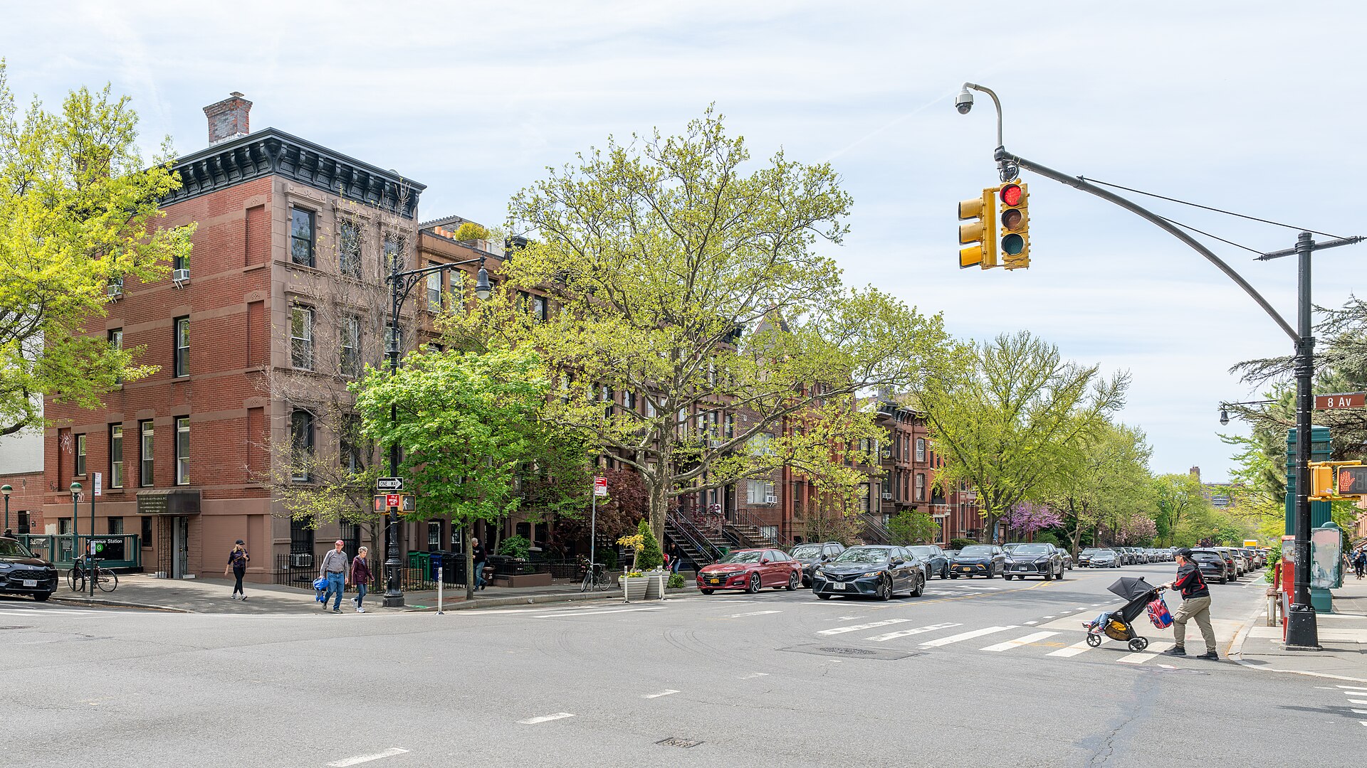 Tree-lined Park Slope street with historic brownstone rowhouses