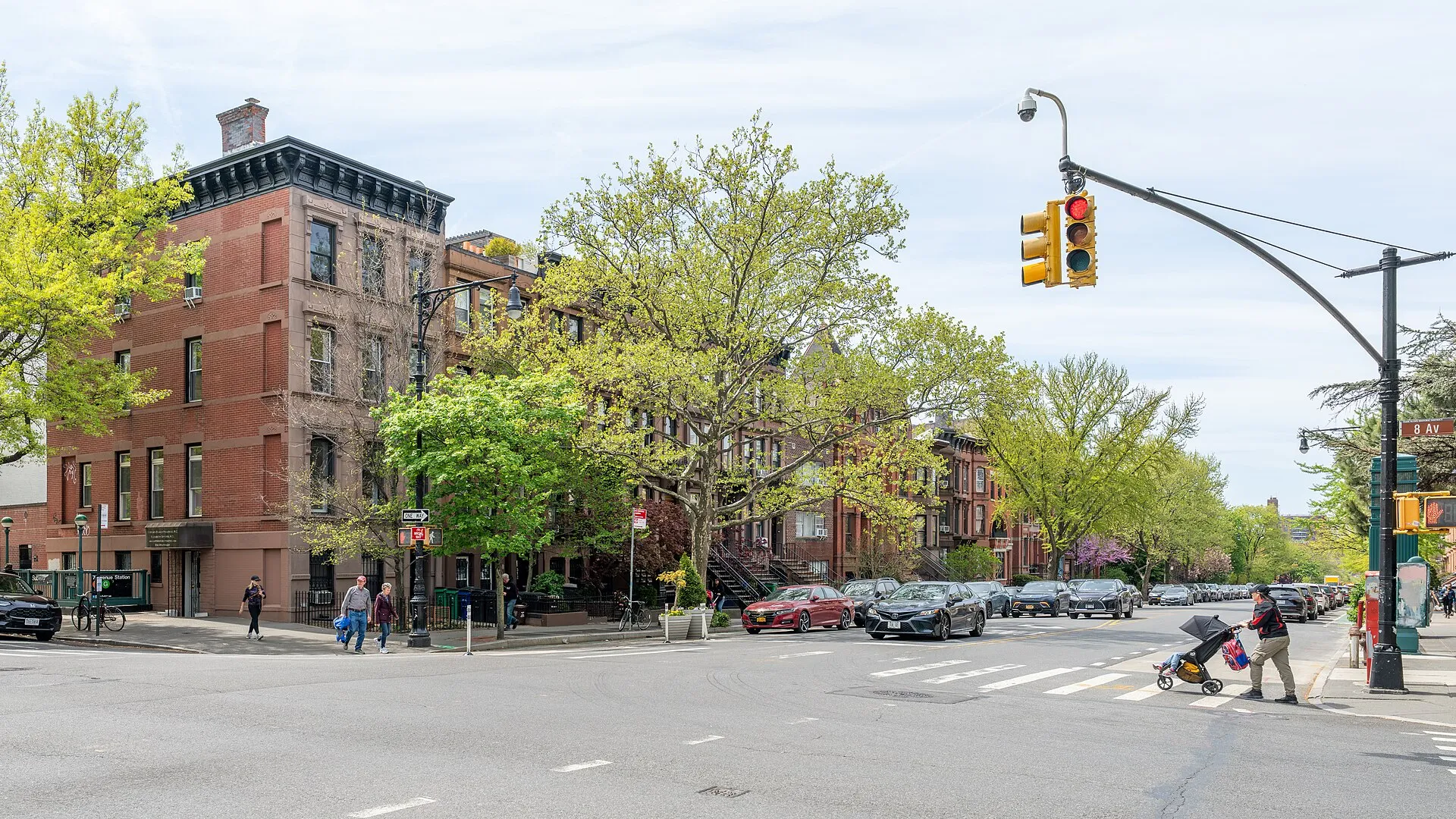 Tree-lined Park Slope street with historic brownstone rowhouses