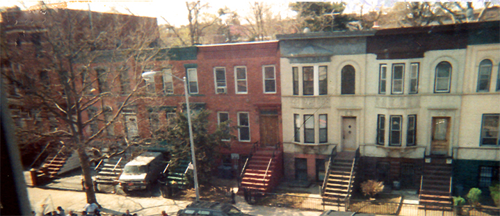 Tree-lined Eastern Parkway with historic brownstones and limestone buildings in Crown Heights