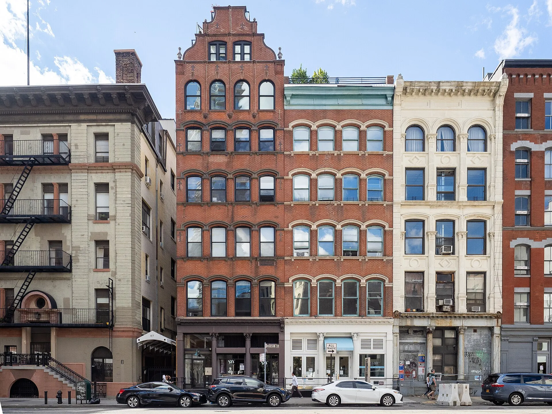 Historic cast-iron loft buildings along a cobblestone street in Tribeca