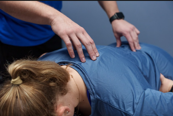 physical therapist guiding a patient through a functional movement assessment