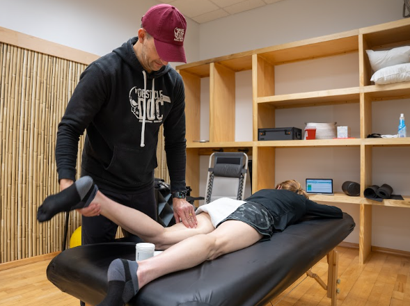  licensed physical therapist guiding a patient through a functional movement assessment