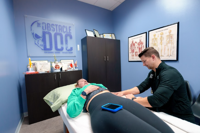  licensed physical therapist guiding a patient through a functional movement assessment
