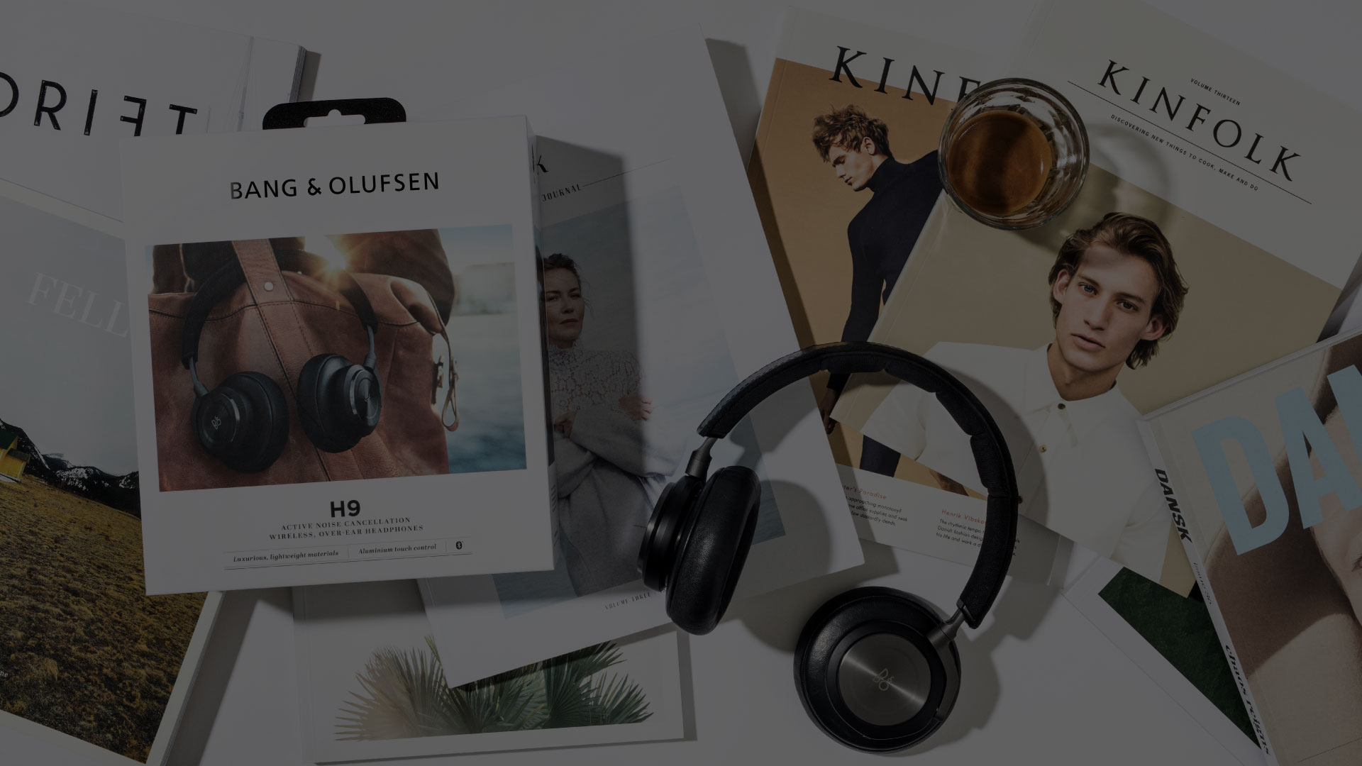 Dramatic shadowed version of the Bang & Olufsen flat lay with H9 headphones and lifestyle magazines. The low-light tone adds cinematic depth while retaining the refined aesthetic. Designed by N96, a Copenhagen-based design studio crafting visionary consumer brands with cultural resonance.