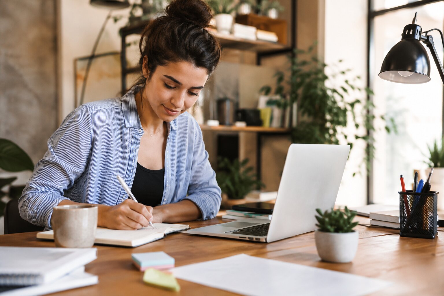 Focused professional planning tasks at a bright home workspace for greater productivity.