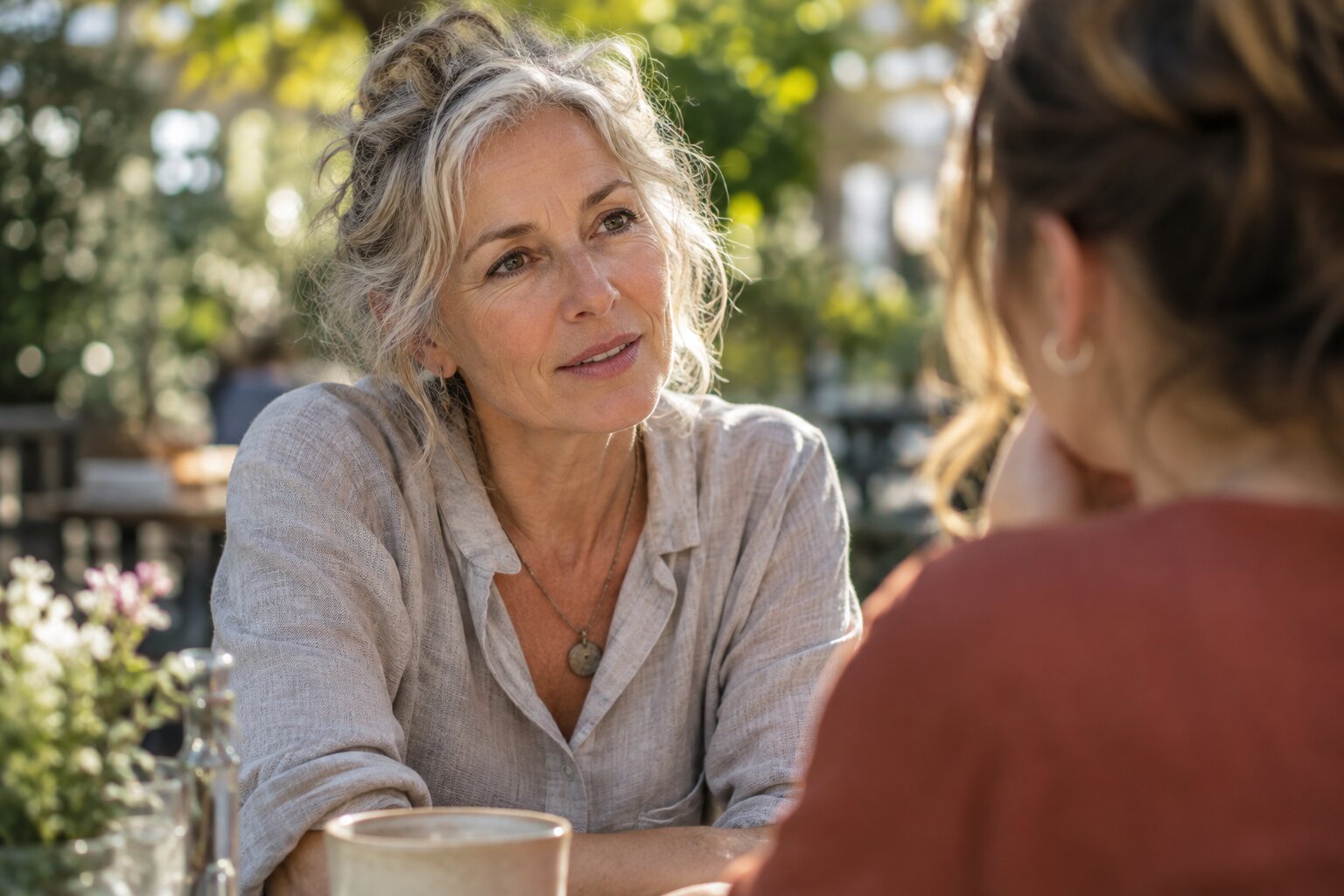 Woman shares her feelings with a friend during a thoughtful outdoor conversation.