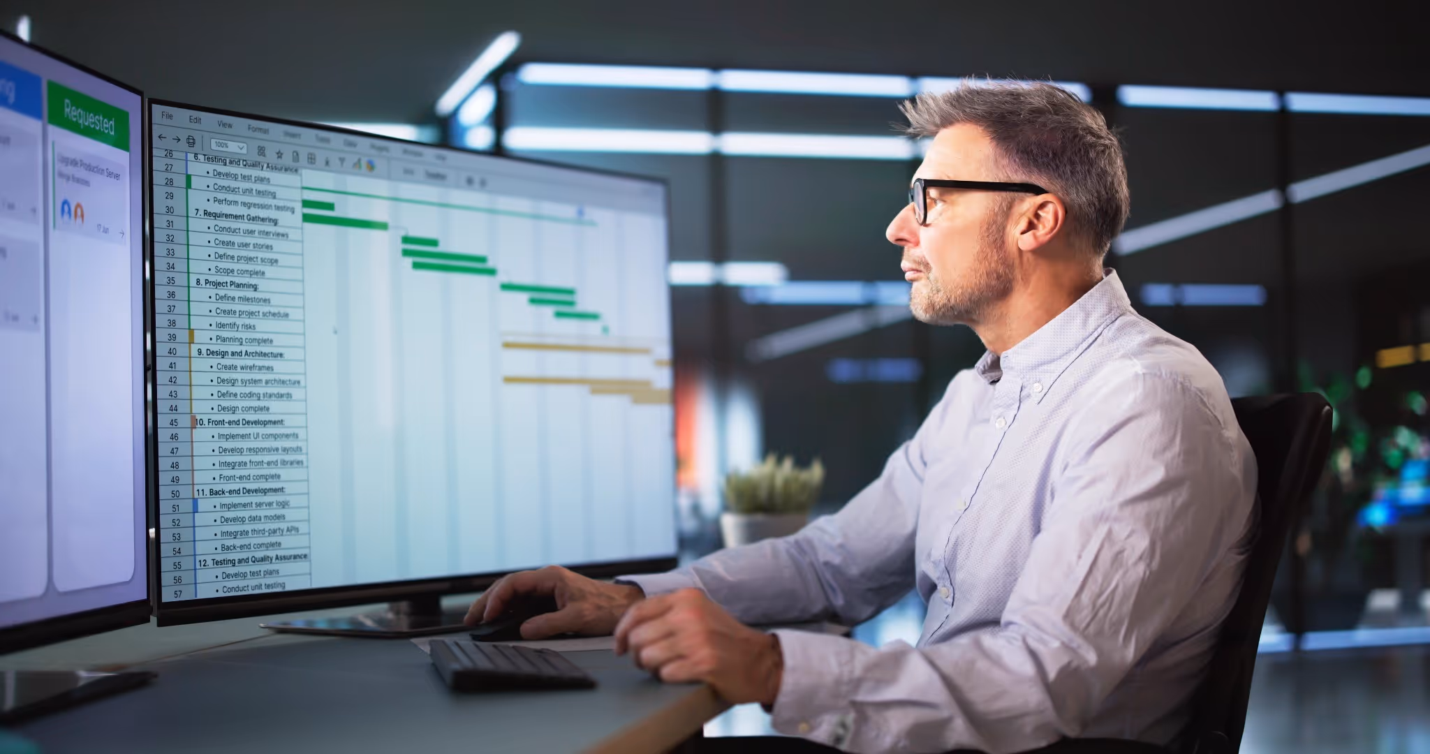 Office worker looking at two computer monitors
