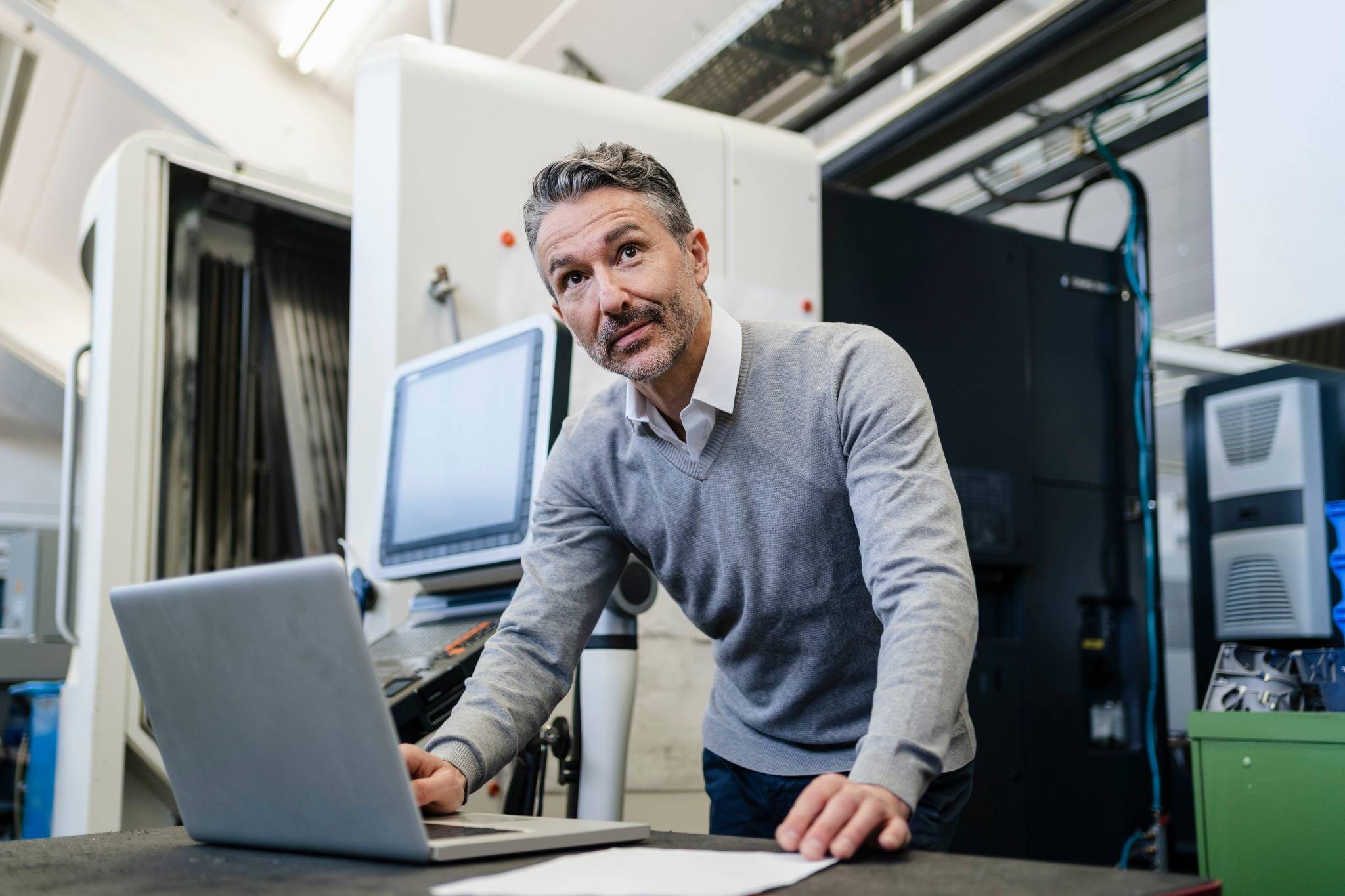 Manager using laptop to monitor performance and profitability
