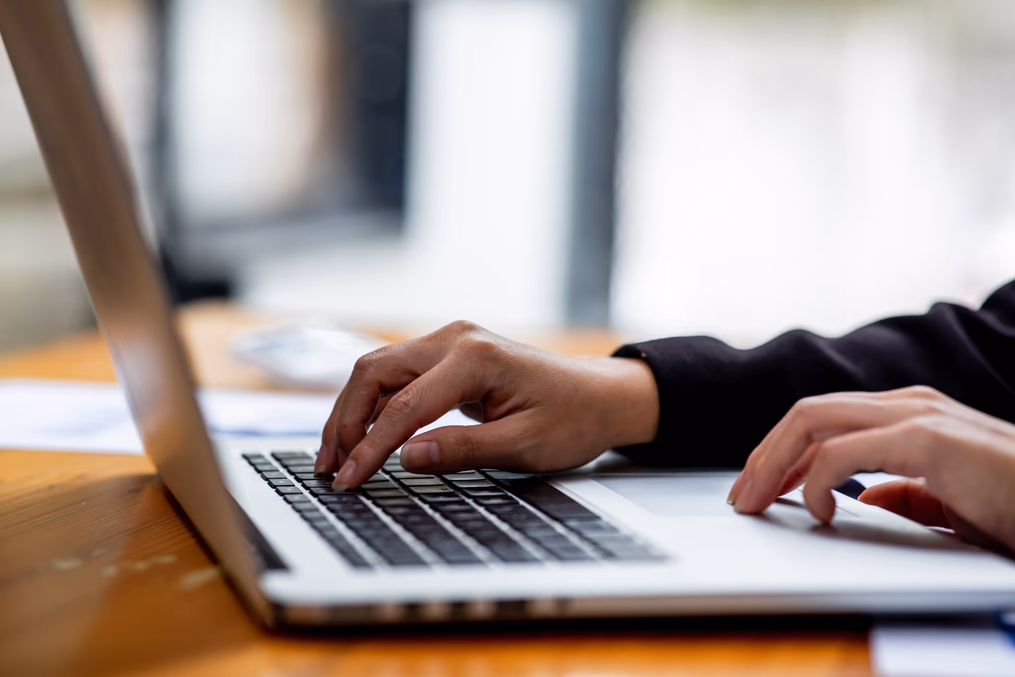 Close up of person typing on laptop