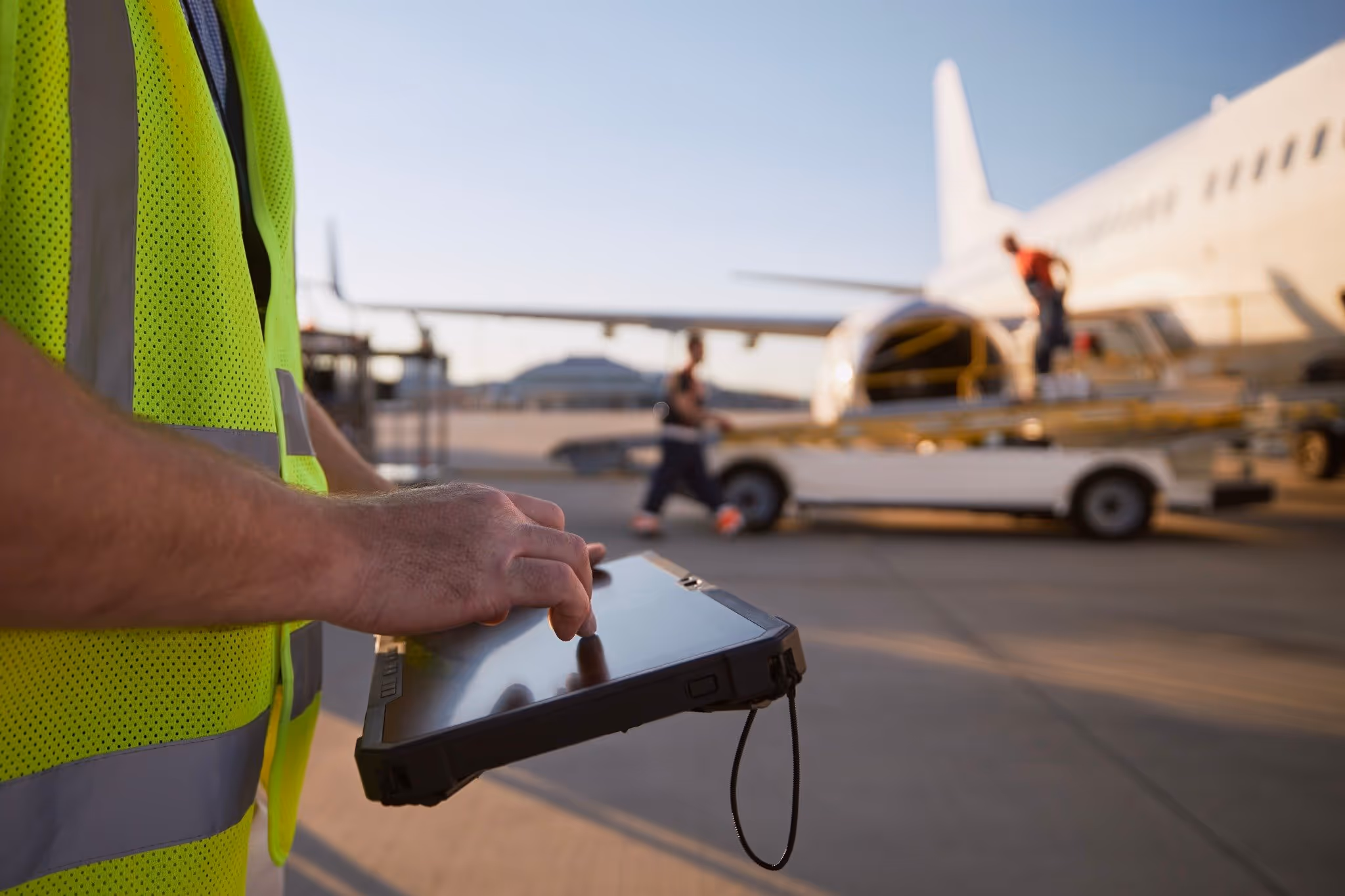 Male worker using tablet for automated ground support