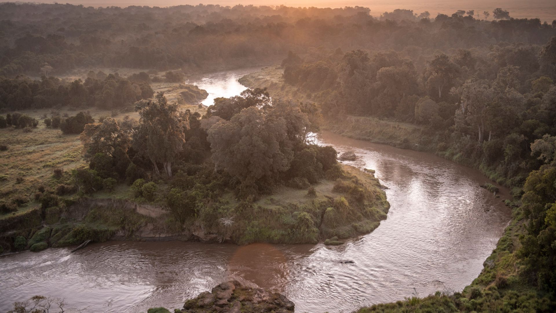 The camp sits right on the Mara River, offering wildlife sightings, hippos, and river sunsets from your tent.
